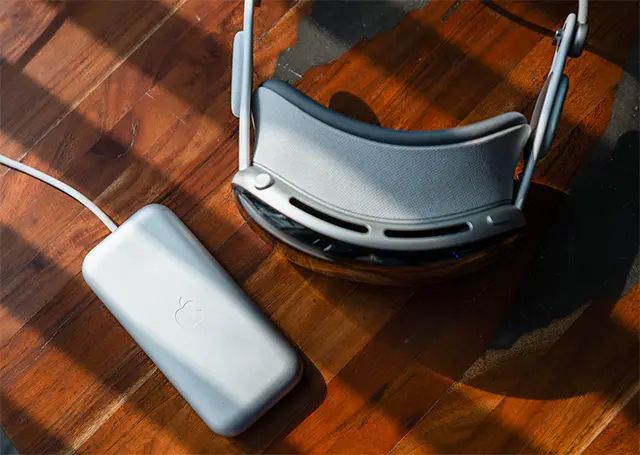 Apple Vision Pro on a table with the charging brick