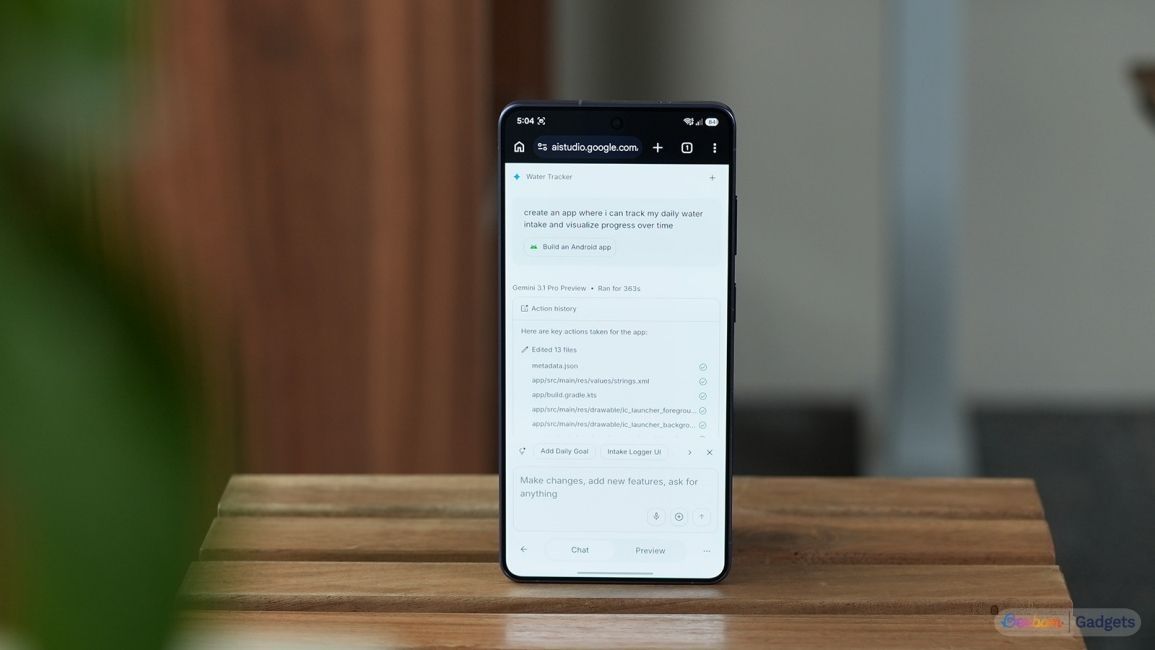 a phone on a table showing ai studio website on screen building android app a phone on a table showing ai studio website on screen building android app