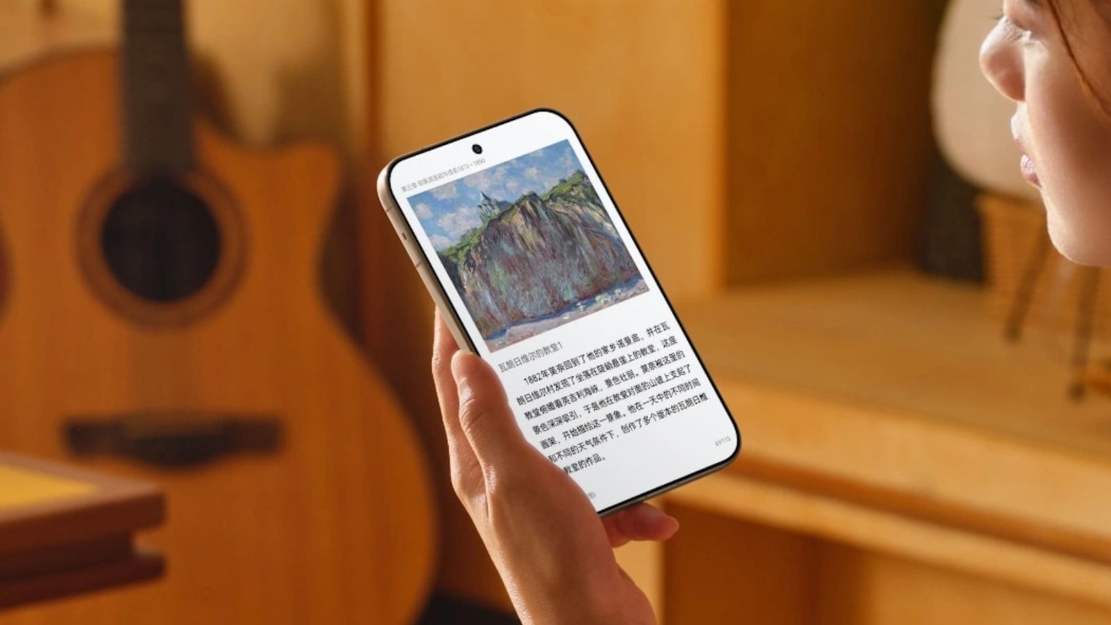 Someone reading a book on the Huawei Pura X View wide display