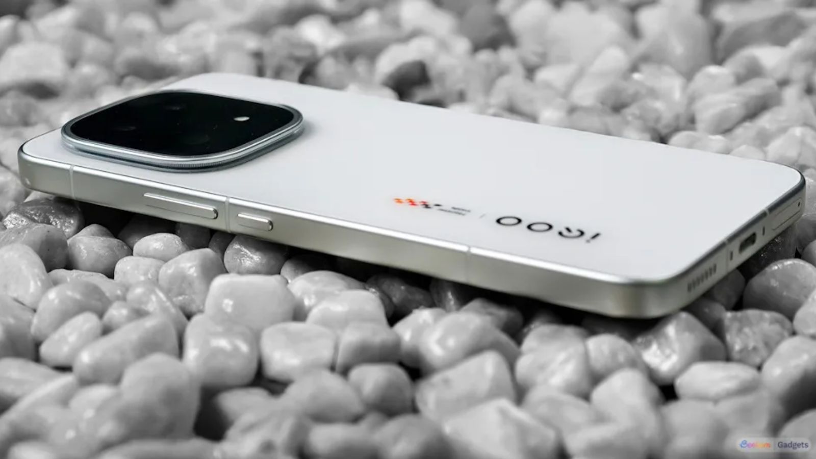 iQOO 15 white back design showcased while the phone is placed face-down on pebbles iQOO 15 white back design showcased while the phone is placed face-down on pebbles