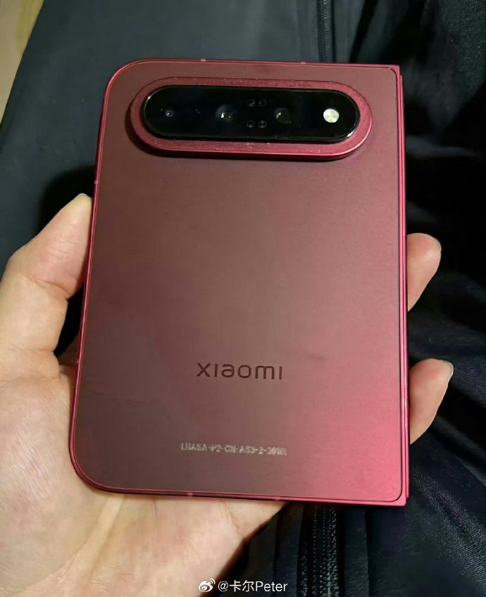 Xiaomi 18 Fold red back design showcased while the wide foldable is in hand