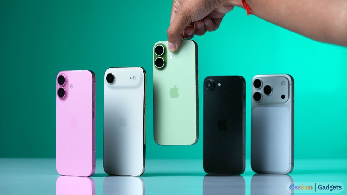 shot of multiple iPhones standing upright on a desk with a hand interacting with them