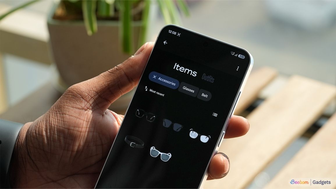 a user holding phone showing segmented items inside the wardrobe page in google photos a user holding phone showing segmented items inside the wardrobe page in google photos