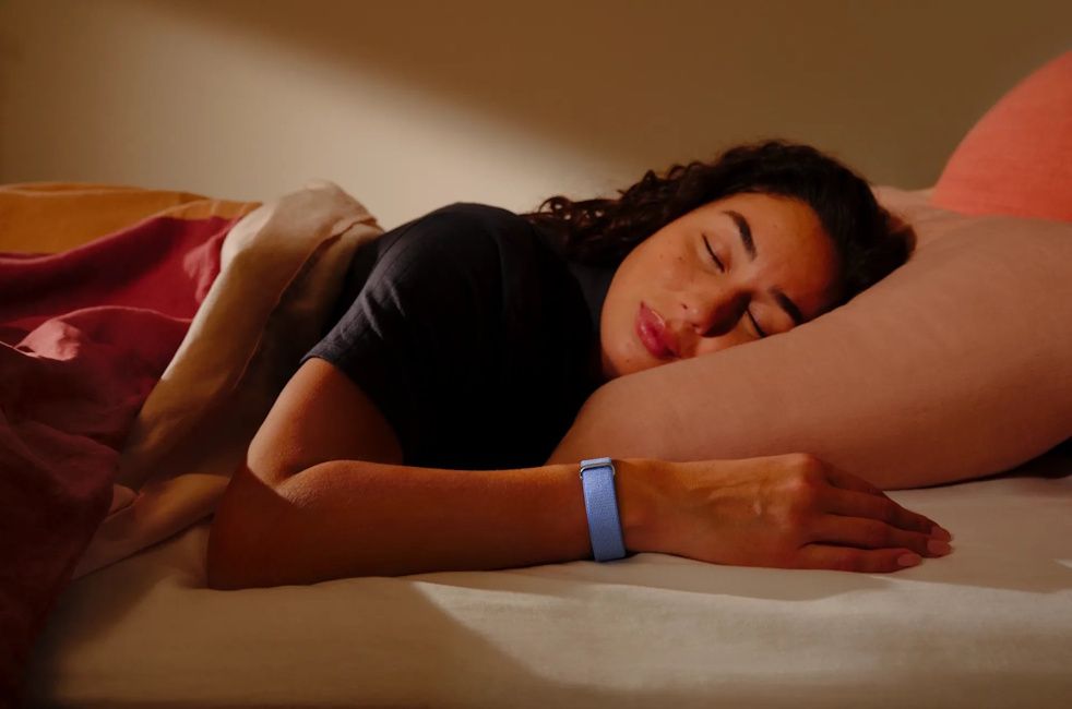 A woman wearing the Fitbit Air while sleeping