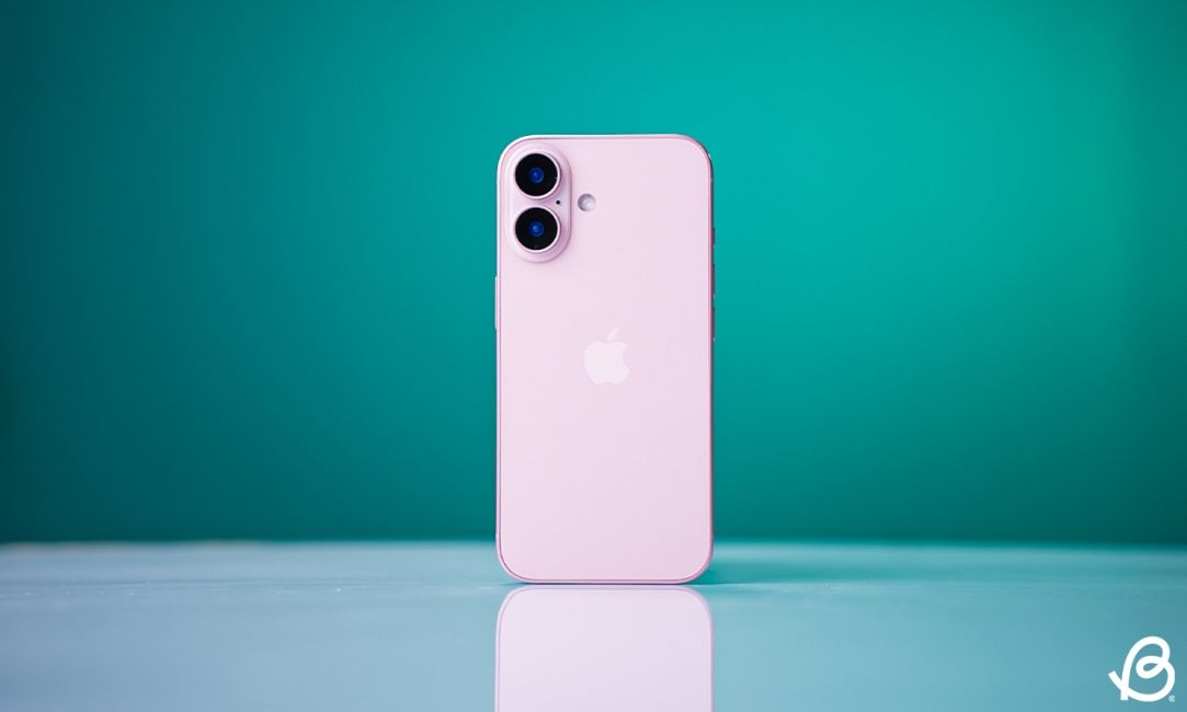 shot of a Pink iPhone 16 standing upright on a desk