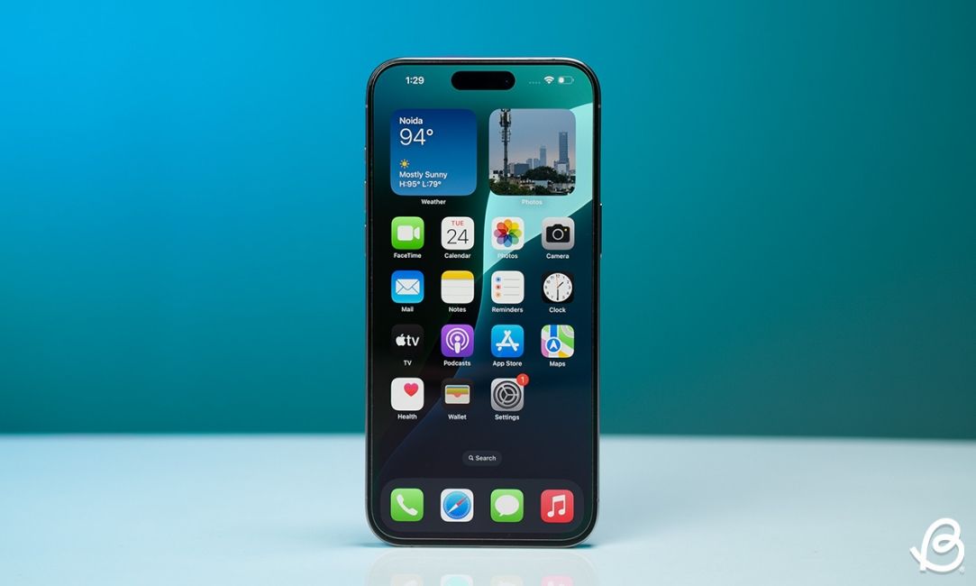 shot of the iPhone 16 Plus standing upright on a desk showing the display