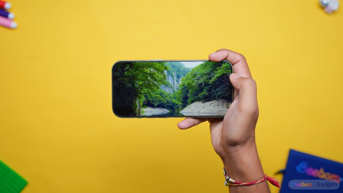 shot of a hand holding an iPhone 17 showing the display in landscape orientation