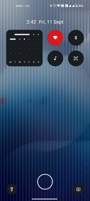 Nothing lock screen with quick setting widgets on blue background