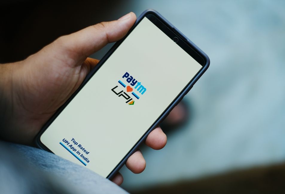 handheld shot of a phone showing the PayTM UPI welcome screen handheld shot of a phone showing the PayTM UPI welcome screen