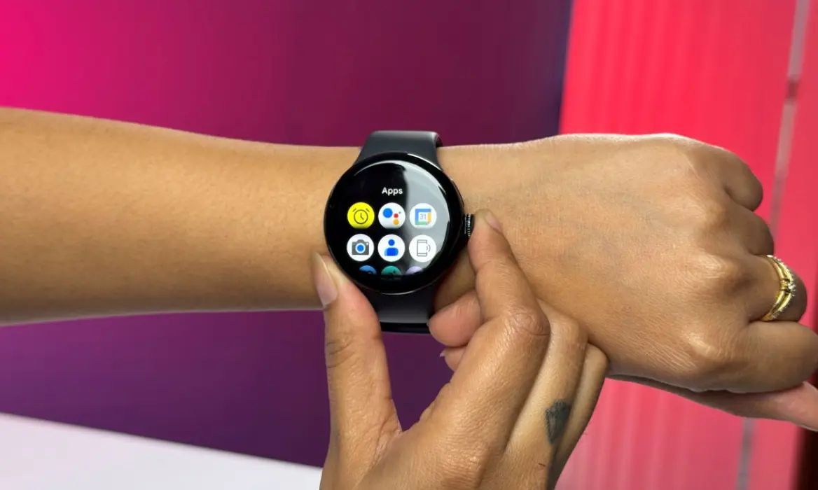 Person wearing a pixel watch pressing on the crown