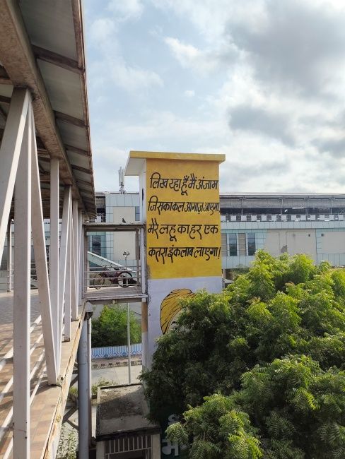 Yellow metro pillar with text shot on Redmi Note 17 Pro Max main camera in daytime