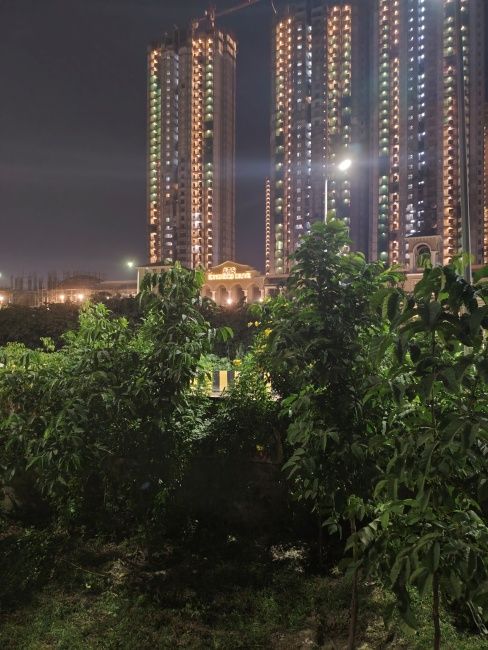 Image of buildings with trees in the foreground shot on Redmi Note 17 Pro Max main camera at night