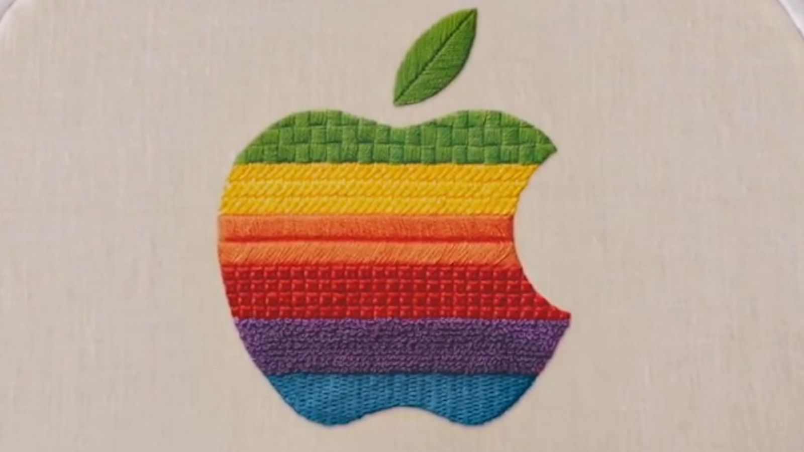 Apple Welcome Home launch event banner showcasing multicoloured Apple logo