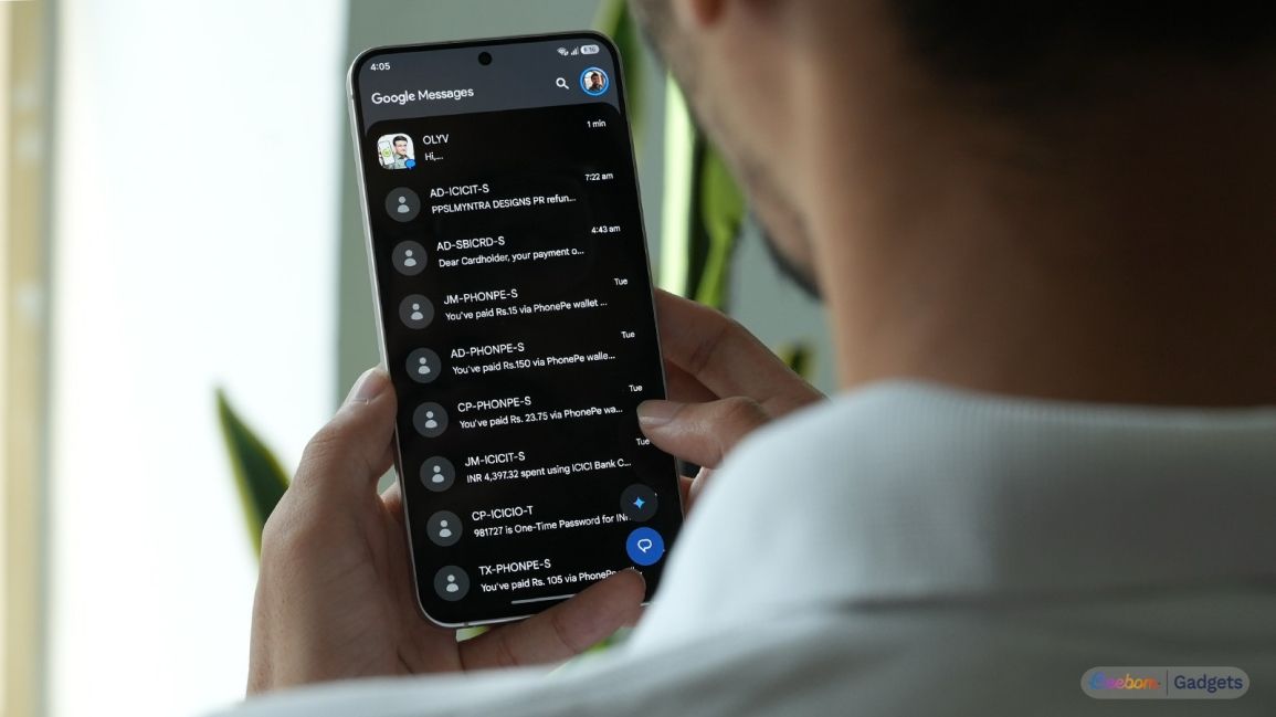 a user holding an android phone showing spammy texts in google messages