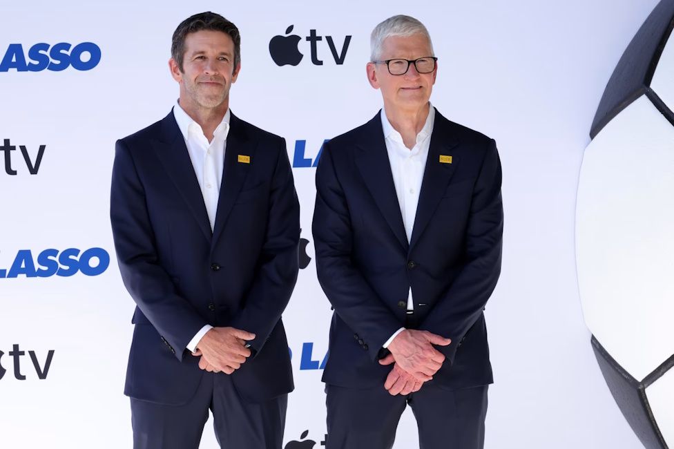 John Ternus and Tim Cook standing together