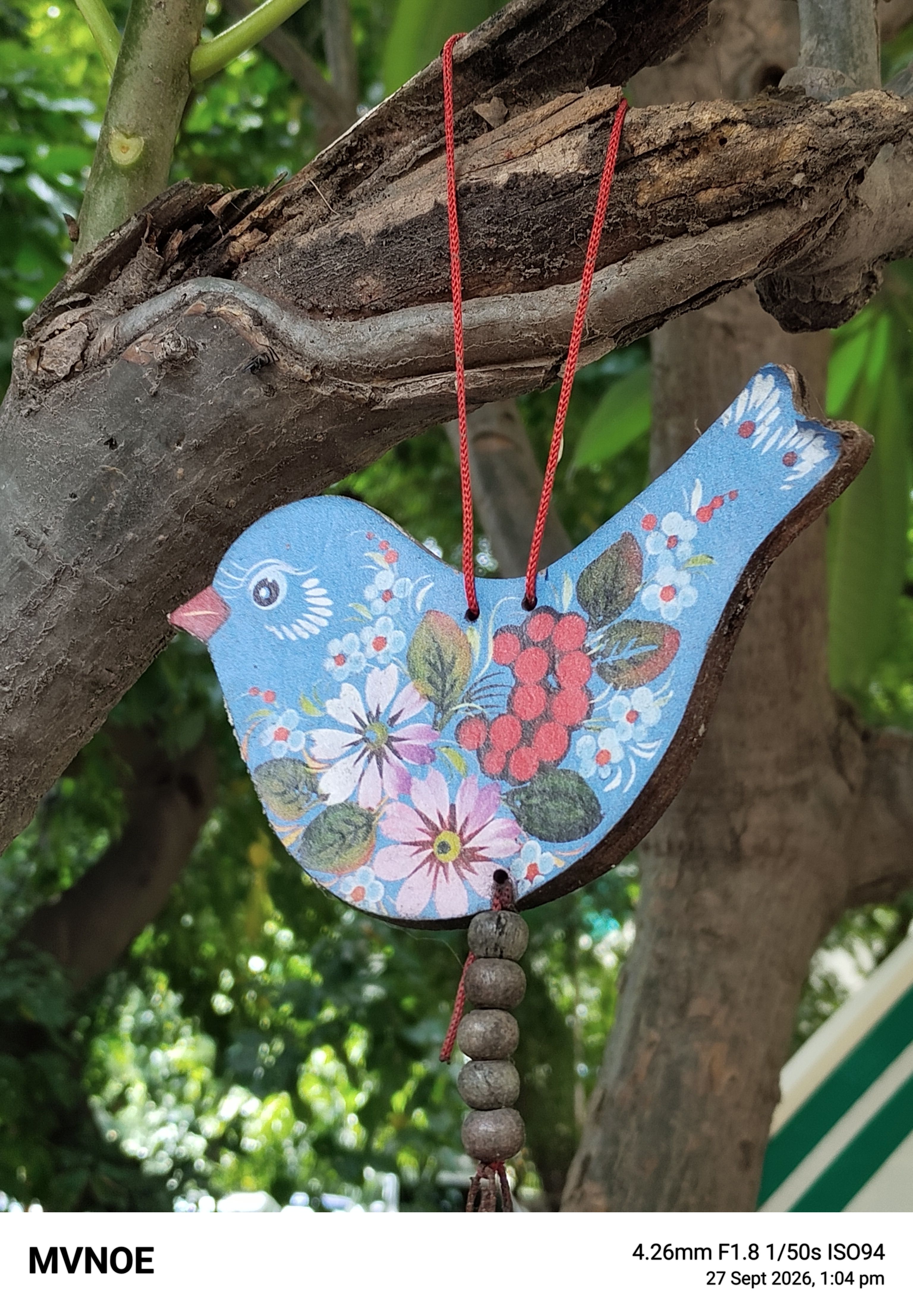 Mivi One 5G primary 2x shot of bird charm Mivi One 5G primary 2x shot of bird charm