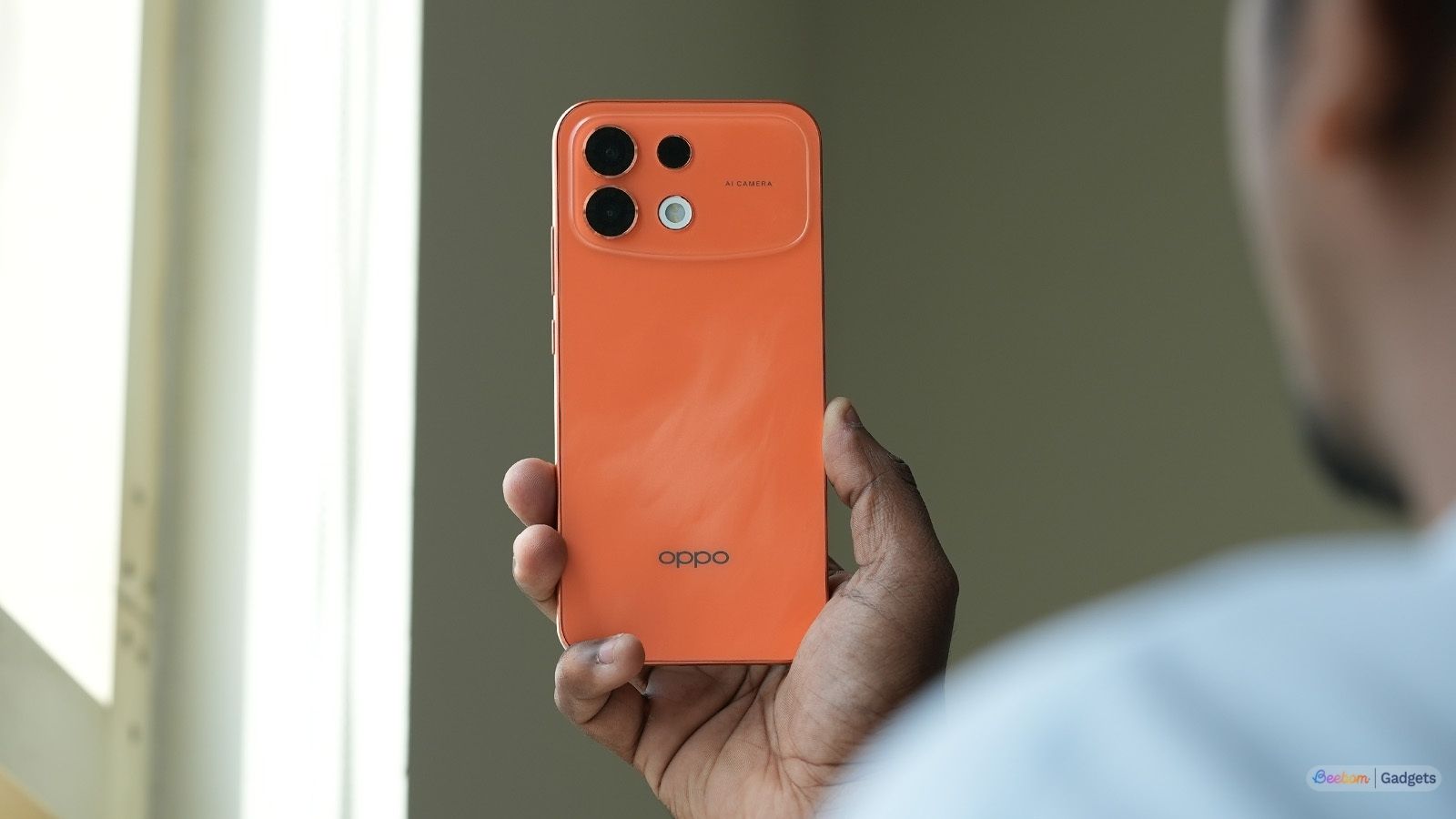 Oppo F35 Pro orange back design showcased while the phone is in hand