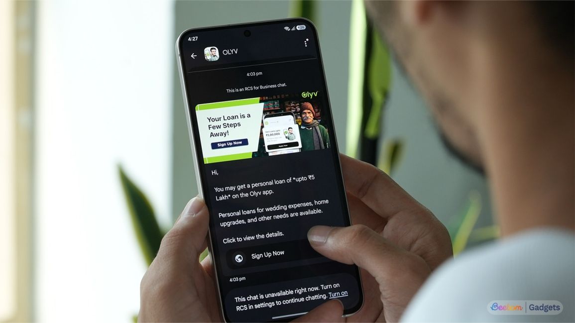 a user holding an android phone showing rcs spam in google messages