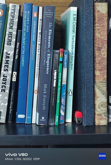 Closeup shot of books and CDs captured on Vivo V80